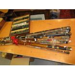 Fifteen various fishing rods and a boxed quantity of fishing floats