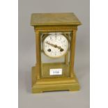 Late 19th or early 20th Century French gilt brass library clock, the four glass case with an urn