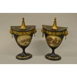 Pair of Regency toleware pedestal chestnut urns and covers painted with landscape vignettes within