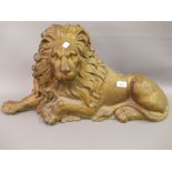Large cast iron gold painted figure of a recumbent lion, having faint foundry / manufacturer stamp