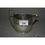George III silver cream jug of oval banded design, marks rubbed and later presentation engraving