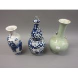 Chinese double gourd shaped vase with cover, decorated with prunus blossom together with a