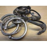 Four silver bracelets together with nine other various torc bracelets including bronze, copper, horn