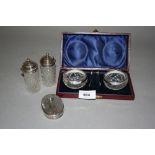 Cased pair of silver mounted glass salts, together with two glass condiments with plated mounts