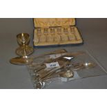 Silver eggcup and stand, an engraved silver tablespoon, cased set of six silver cake forks and other