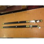 Pair of reproduction swords in simulated leather and brass scabbards
