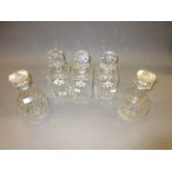 Set of three cut glass decanters with facet cut stoppers and porcelain labels by Royal Adderley