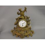 Small 19th Century gilded spelter mantel clock with figural surmount, the enamel dial with Roman