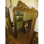 19th Century gilt framed wall mirror having shell, C scroll and floral surmount with a plain