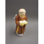 Royal Worcester candle snuffer in the form of a monk reading from a book