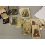 Quantity of military badges and buttons, collection of early photographs and a cased Churchill