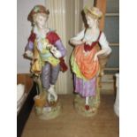 Pair of large late 19th Century Continental porcelain figures of a lady and gentleman decorated with