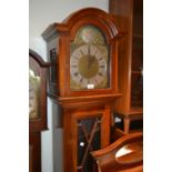 Mid 20th Century mahogany longcase clock with an arched hood above glazed door, raised on bracket
