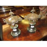 Pair of 19th Century French brown patinated bronze covered urns on marble and slate plinth bases