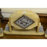 Art Deco beige and grey onyx three piece clock garniture, the silvered diamond shaped dial signed La
