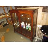 Mid 20th Century mahogany display cabinet with two glazed doors, raised on low cabriole supports