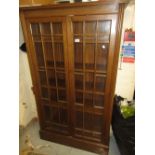 Early 20th Century mahogany two door bookcase with bar glazed doors enclosing shelves above a plinth