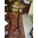 Early 20th Century carved mahogany torchere with a shaped moulded top above a fluted column