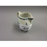 18th Century English blue and white oviform miniature jug, decorated with stylized flowers in a