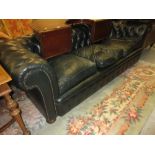 20th Century Chesterfield button back three seat sofa in dark green, with loose cushions and bun