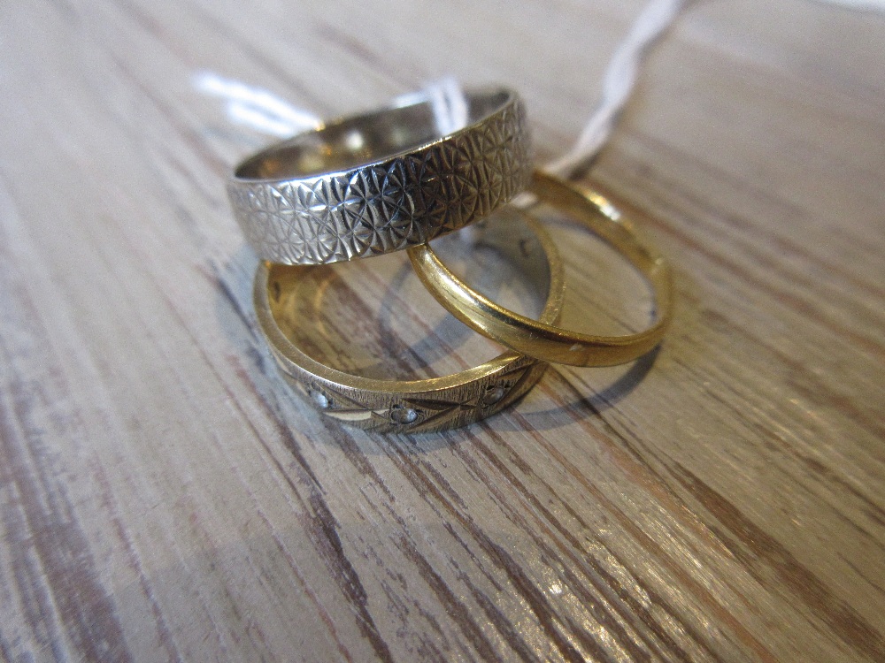 22ct Gold wedding band, a 9ct white gold wedding band and a 9ct yellow gold eternity ring