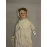 Diamond Pottery Company, English bisque headed doll with fixed eyes, open mouth and two teeth, 21ins