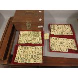 Chinese bone and bamboo mahjong set in a later made casket, retaining original trays (at fault),