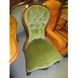 Victorian carved walnut and button upholstered open arm drawing room chair with floral surmount