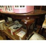 Small early 20th Century oval mahogany wind-out extending dining table with single extra leaf,