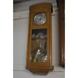 Early 20th Century oak Vienna style wall clock, the silvered dial with Arabic numerals above a