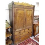 19th Century Irish mahogany linen press, the shaped top above two panelled doors with two short