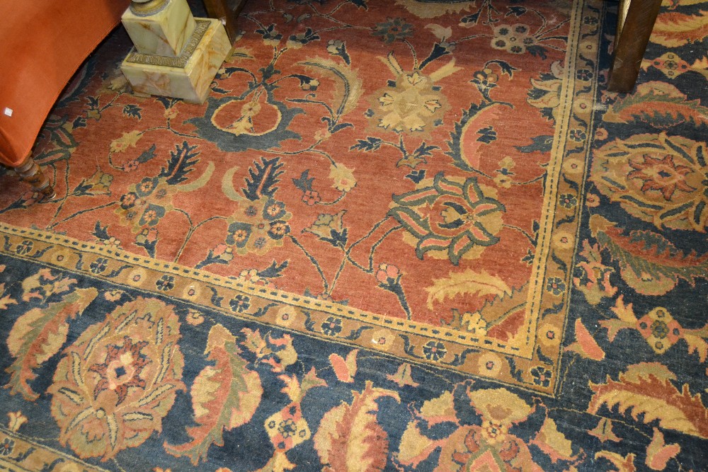 Agra carpet of all-over floral design on a burgundy ground with multiple borders, 116ins x 160ins (