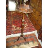 Mahogany torchere with octagonal galleried top above a baluster column and carved tripod base