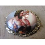 19th Century oval porcelain brooch painted with figures in a gold plated mount