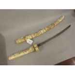 Japanese short sword with carved bone scabbard and grip