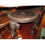 19th Century Indian carved hardwood circular occasional table, the engraved brass tray top on