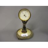 19th Century gilt brass and onyx desk barometer, the enamel dial within a drum form case supported