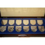 Cased set of twelve silver ingots, Royal coats of arms, together with a cased set of ten silver