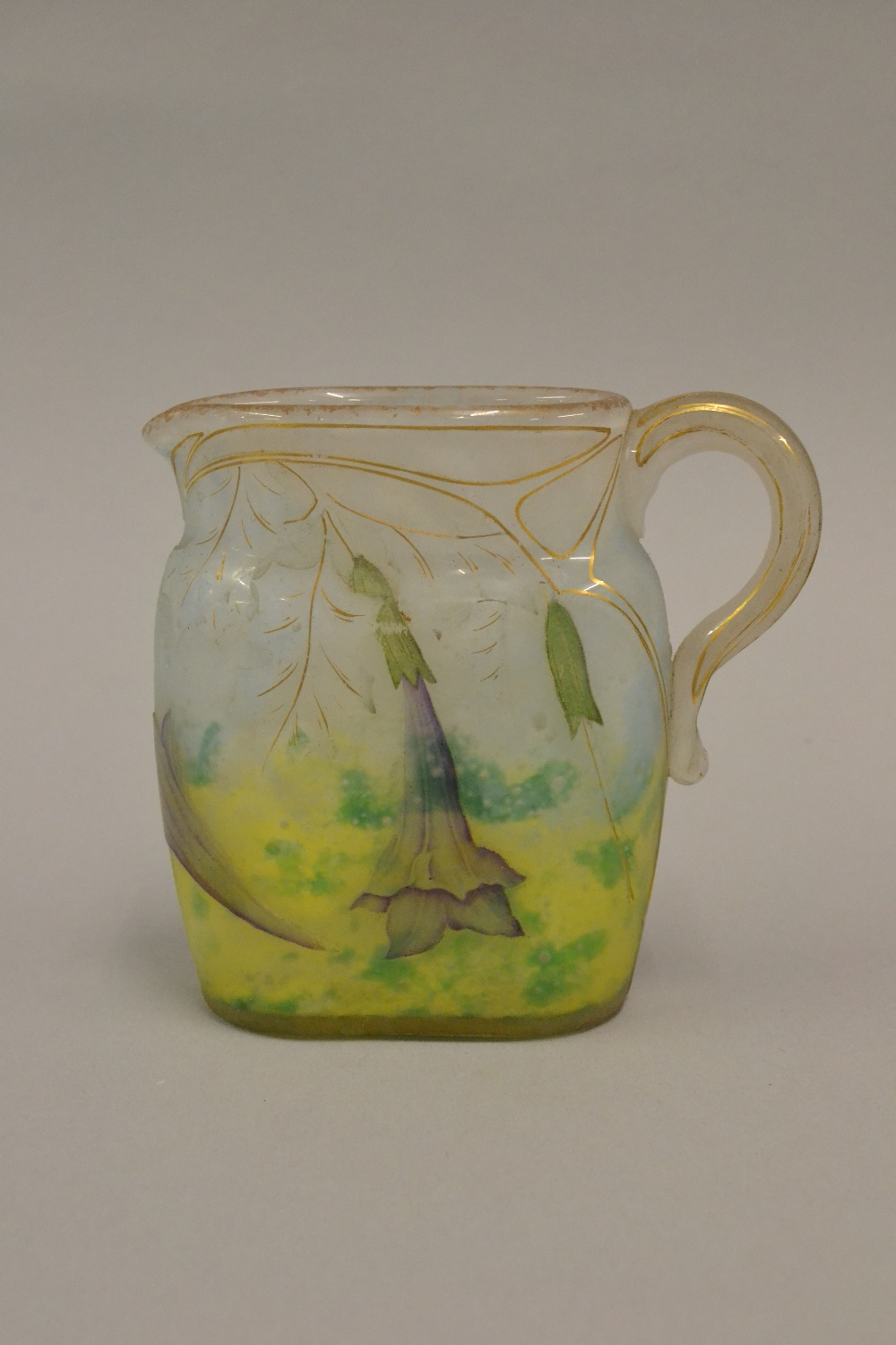 Daum Nancy cameo glass miniature jug of oval form, carved in shallow relief with trailing flowers,