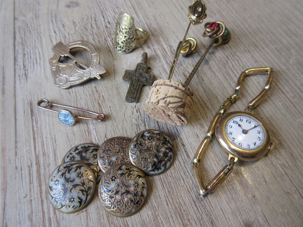 Small bag containing a ladies gold plated wristwatch, various tie pins, buttons etc