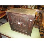 18th Century oak spice cabinet having single panelled door with geometric moulded panels enclosing a