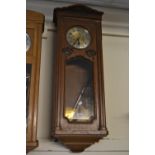 Early 20th Century oak Vienna type wall clock the gilt and silvered dial with Arabic numerals, the