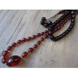 Two amber coloured bead necklaces