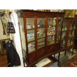 Edwardian mahogany and inlaid inverted bow front display cabinet, the moulded cornice above two