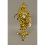 19th Century gilt brass mantel timepiece cast with figures with later replacement movement