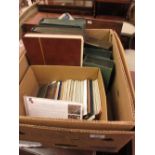 Box containing a quantity of albums housing a collection of various early 20th Century topographical