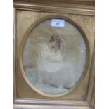 Regency oval silkwork picture of a seated lady with child, gilt framed
