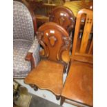 Pair of Victorian mahogany hall chairs, the shaped carved and pierced backs above shaped panel seats