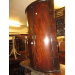 George III mahogany two door bow front hanging corner cabinet