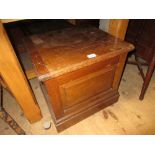 Early 20th Century oak commode with hinged cover and panelled front on plinth base